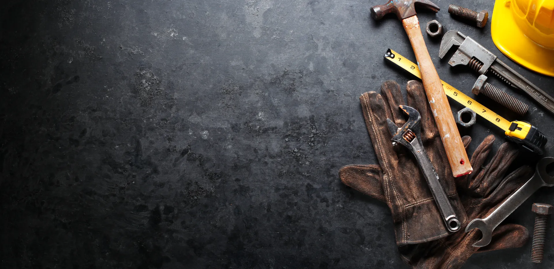 Professional handyman tools on dark workbench