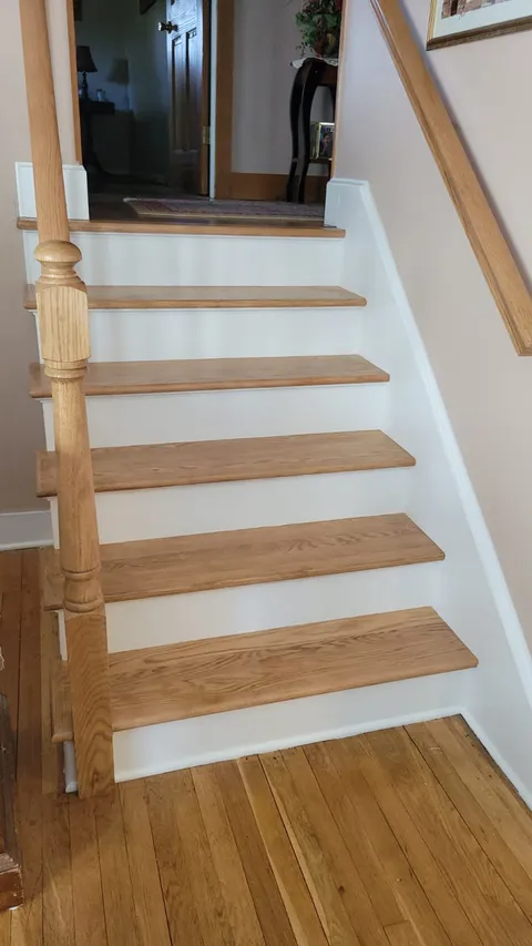 Oak stairway refurbishment by Pro Handyman Services — custom treads, risers, and newel post