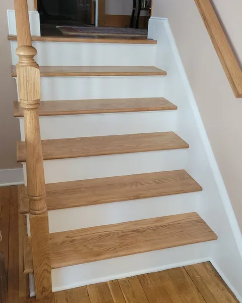 Oak stairway refurbishment by Pro Handyman Services — custom treads, risers, and newel post