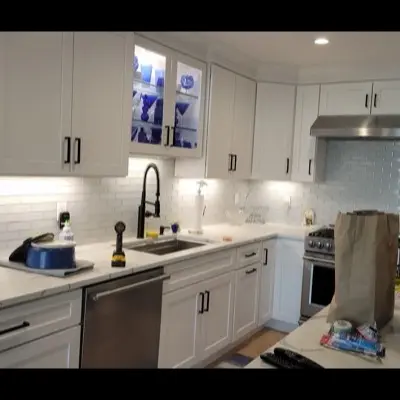 Full kitchen renovation with quartz countertops and subway tile backsplash